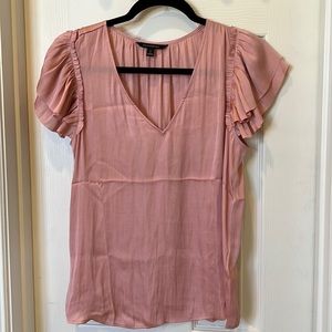 Soft pink blouse with ruffle detail on sleeves